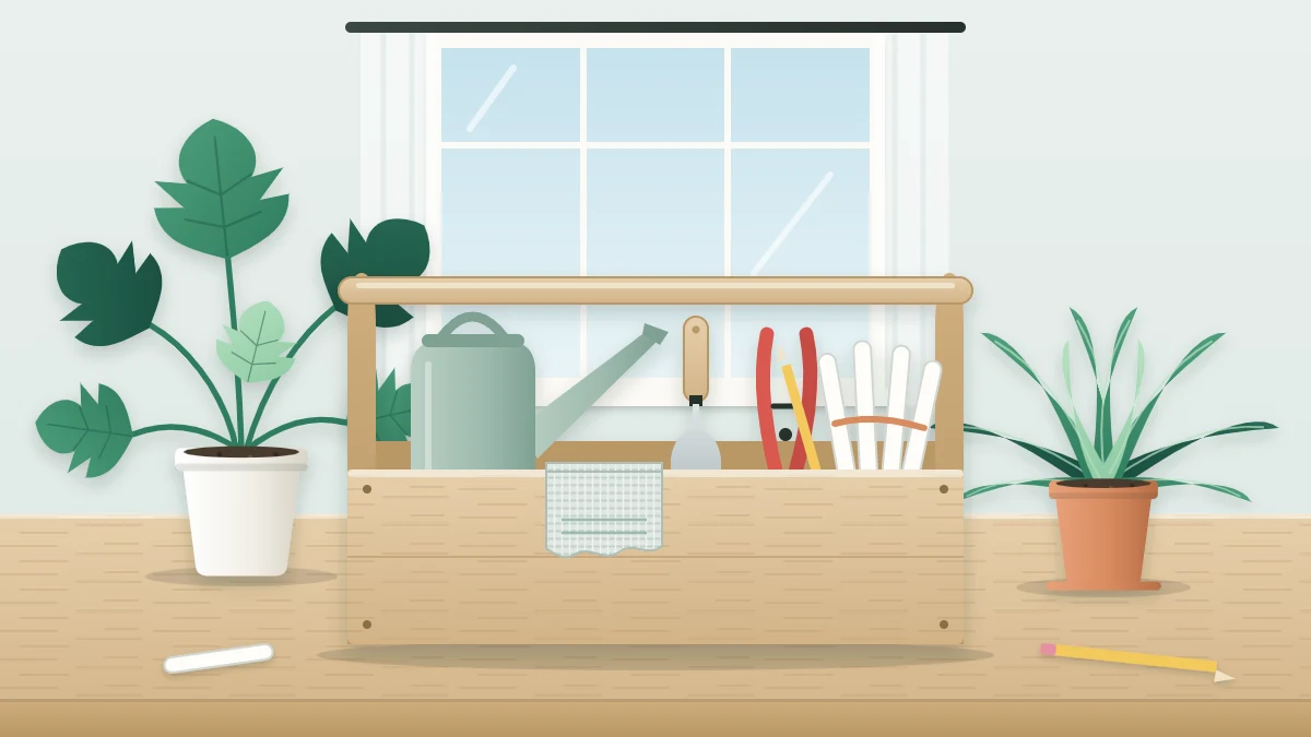An open wooden caddy holding a long-spout watering can, snips, a hand trowel, a cloth and blank plant labels, with two potted plants behind